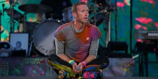Coldplay’s Chris Martin sitting cross-legged