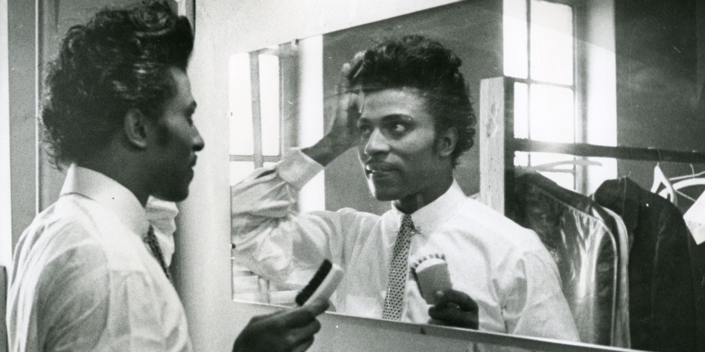 Little Richard fixing his hair in a mirror in 1956